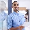 smiling young african american man with tablet
