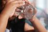 A Young Child Enjoying a Glass of Refreshing Water