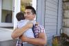 father hugging his baby