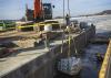 a diver at Lock and Dam 4 prepares to place sandbags at the bottom of the concrete forms
