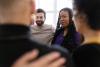 Diverse group of people standing in a huddle during therapy session