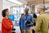 Multiracial business people discussing while meeting at launch event