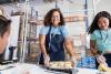 smiling woman preparing food in a tray