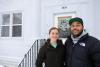 happy couple in front of a home