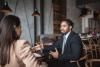 man in suit talking with woman