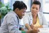 woman tutoring a young man