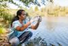 Young Woman Collecting Water Samples for Environmental Conservation