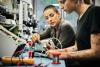 Female technician guiding young trainee