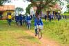 malaria control workers biking from a village in uganda