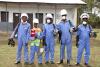 men and women in Africa wearing mosquito spraying gear