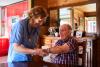 medical professional making home visit to care for elderly man