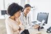 doctor talking to a patient while they both look at a tablet