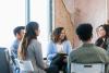  a group of people sitting in a circle chatting