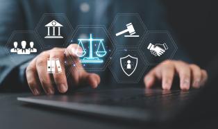 A suited legal professional touches virtual icons symbolizing law, justice, and legal services
